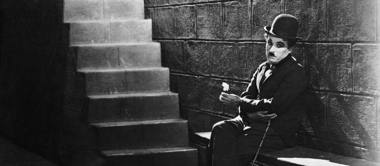 Let's start under the warm glow of the silent screen with a beloved actor whose bowler hat, cane, and mustache defined the timeless character of “the tramp.” Who is this iconic gentleman?