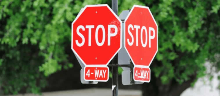 When you pull up to a four-way stop on a dusty summer road, who gets to roll on through first?