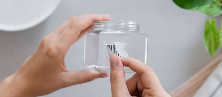 Say you have a stubborn price tag stuck on a sweet new glass pitcher—what is the gentlest way to coax it off?